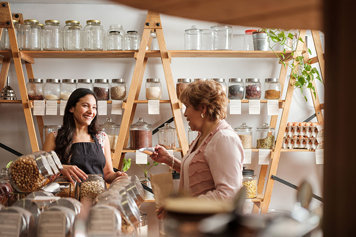 Lady talking to shop owner